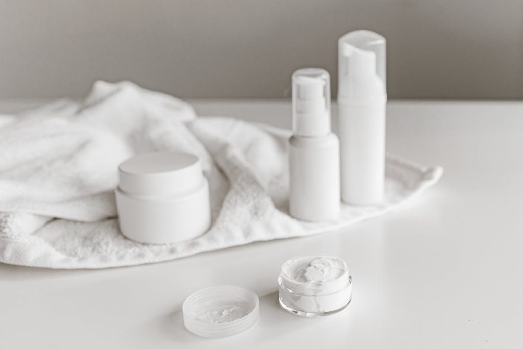 PDRN serum and cream side by side on a marble countertop with morning sunlight, showing texture difference